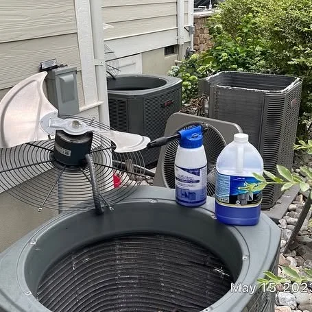 Outdoor HVAC unit and maintenance materials ready for service.